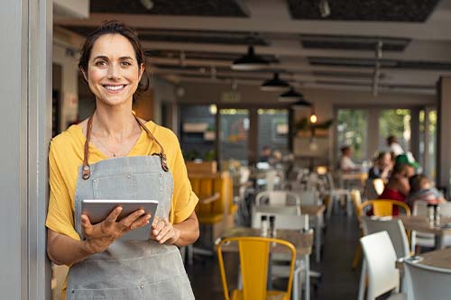 small business woman standing outside her restaurant